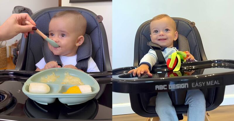 Bebê sorridente comendo em cadeira alta